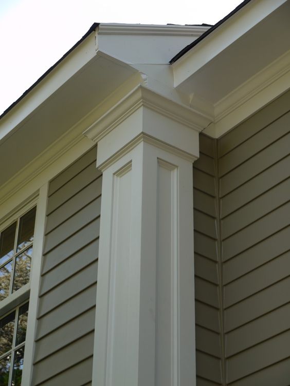 Tan horizontal vinyl lap siding with white PVC trim on a New Jersey home